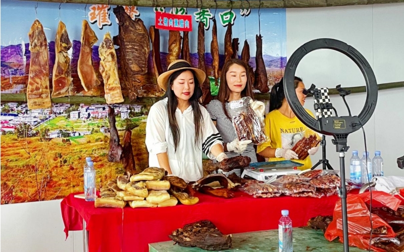 郧西县香口香腊味专业合作社员工正在直播间销售腊肉。孟鑫杰摄